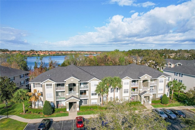 birds eye view of property with a water view and a residential view