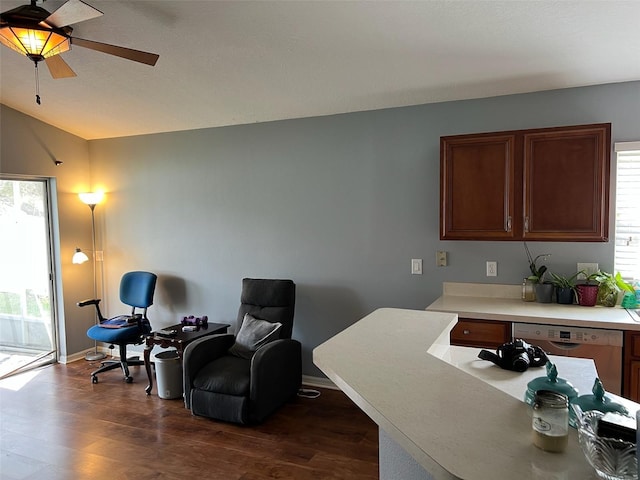 office area featuring dark wood-style floors, ceiling fan, vaulted ceiling, and baseboards