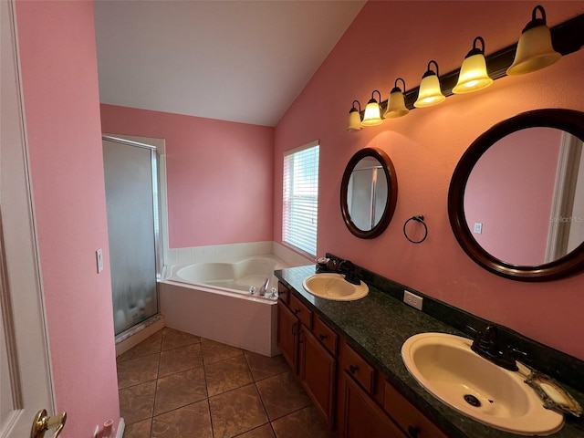 full bathroom featuring a garden tub, vaulted ceiling, tile patterned flooring, and a sink