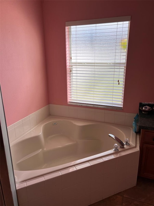 full bath with vanity, a bath, and tile patterned floors