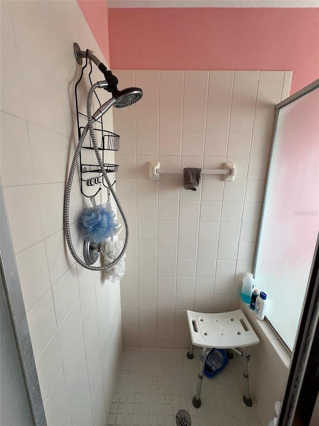 full bath featuring a tile shower