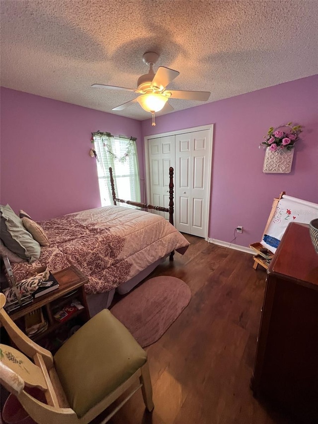 bedroom with a textured ceiling, a closet, wood finished floors, and a ceiling fan