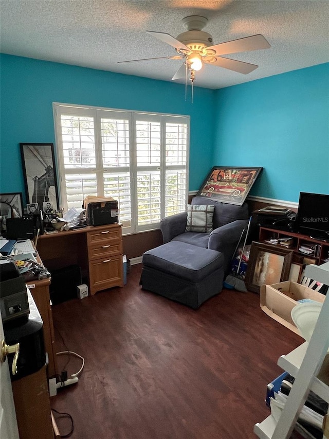 office with a ceiling fan, dark wood-type flooring, and a textured ceiling