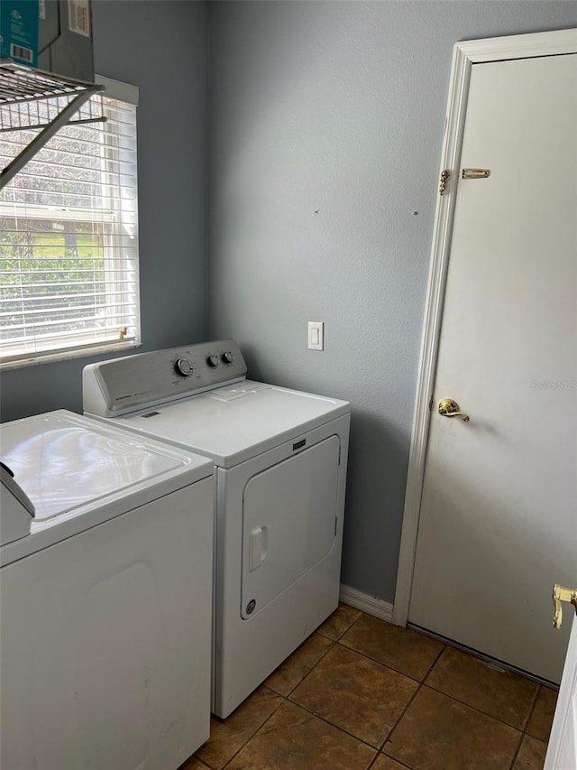 clothes washing area with laundry area, tile patterned flooring, and washing machine and dryer