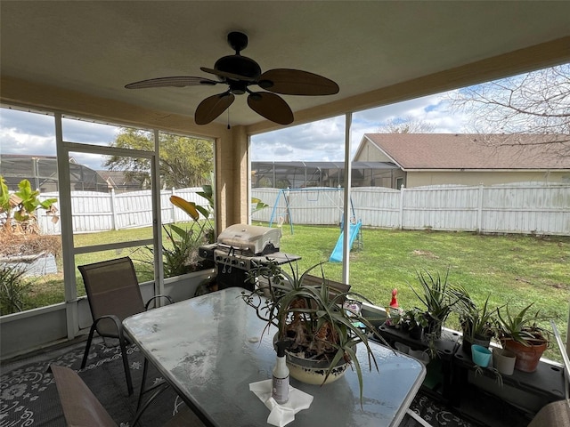 sunroom / solarium with a ceiling fan