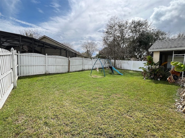 view of yard featuring a playground and a fenced backyard