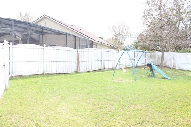 view of yard with a playground and a fenced backyard