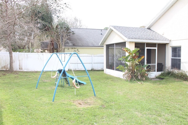 view of yard featuring a sunroom and a fenced backyard