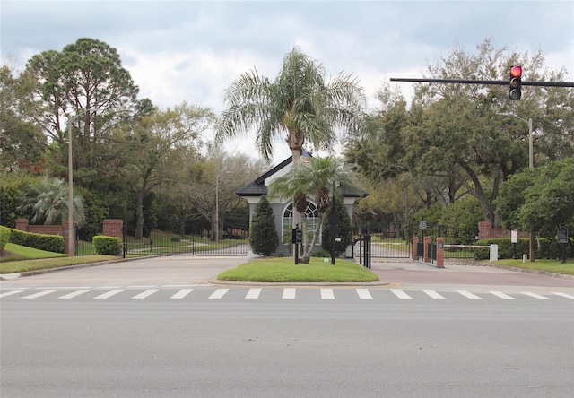 surrounding community featuring a gate, fence, and a yard