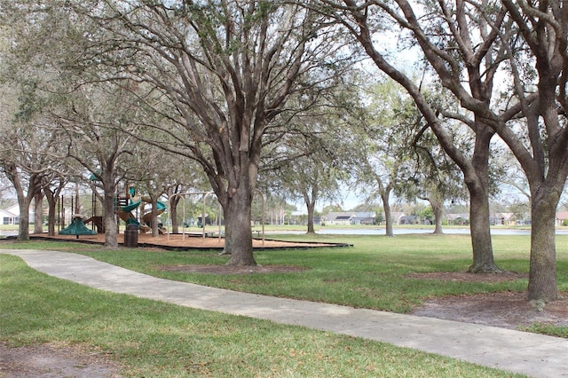 view of community featuring playground community and a lawn