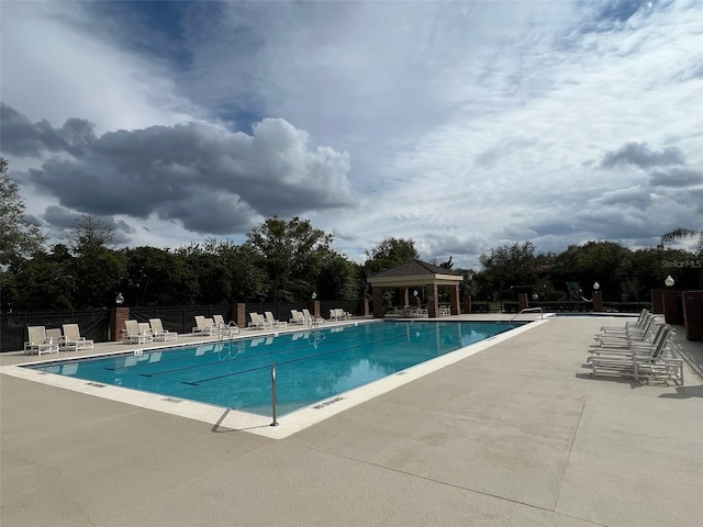 pool featuring a patio area, fence, and a gazebo