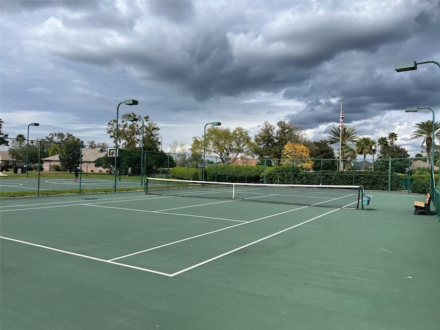 view of tennis court featuring fence