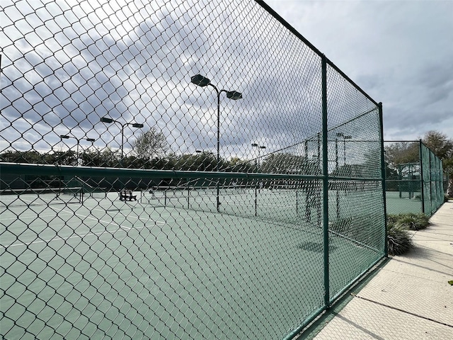 view of sport court featuring fence