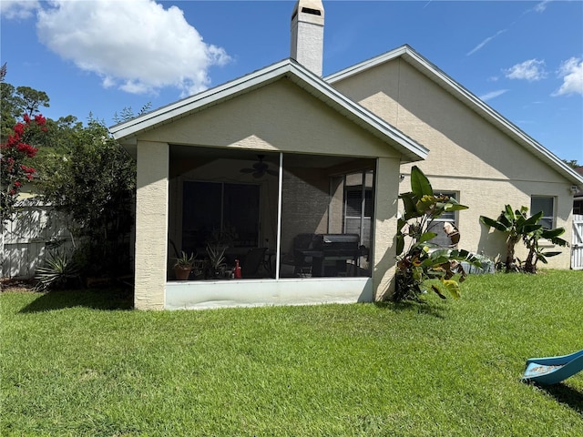 536 Dunoon St, Ocoee, FL 34761 - rear view of house with a sunroom, a lawn, and stucco siding