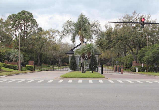536 Dunoon St, Ocoee, FL 34761 - view of asphalt road with a gate, curbs, and a gated entry