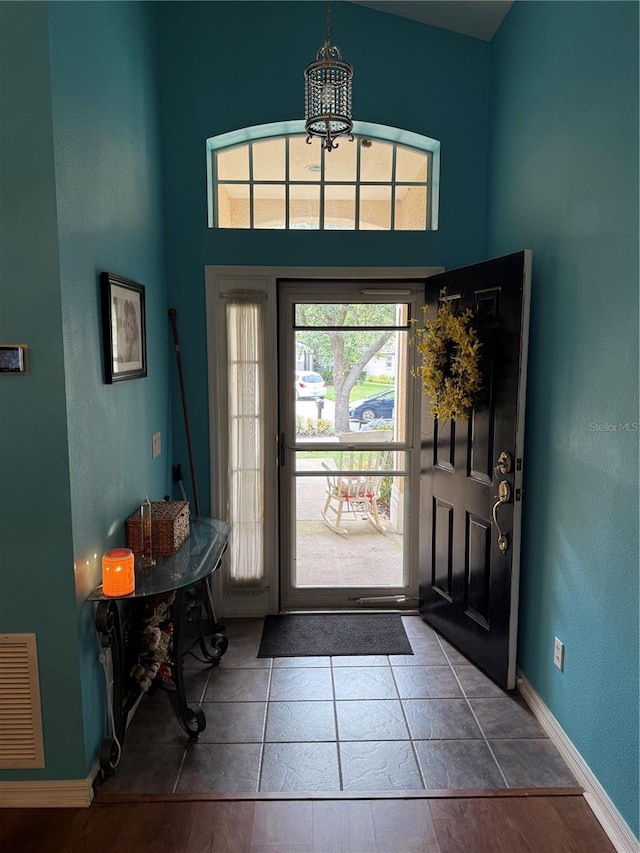 536 Dunoon St, Ocoee, FL 34761 - foyer entrance with a chandelier, a high ceiling, and tile patterned floors