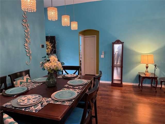 536 Dunoon St, Ocoee, FL 34761 - dining area with dark wood-style floors, arched walkways, and a high ceiling