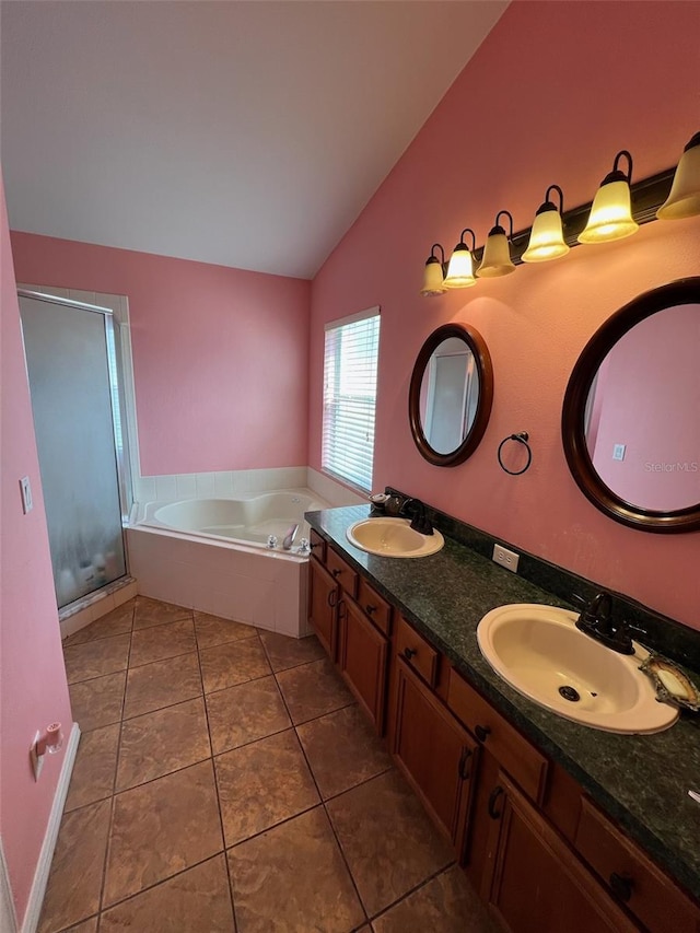 536 Dunoon St, Ocoee, FL 34761 - full bathroom featuring vaulted ceiling, a garden tub, tile patterned floors, a shower stall, and double vanity