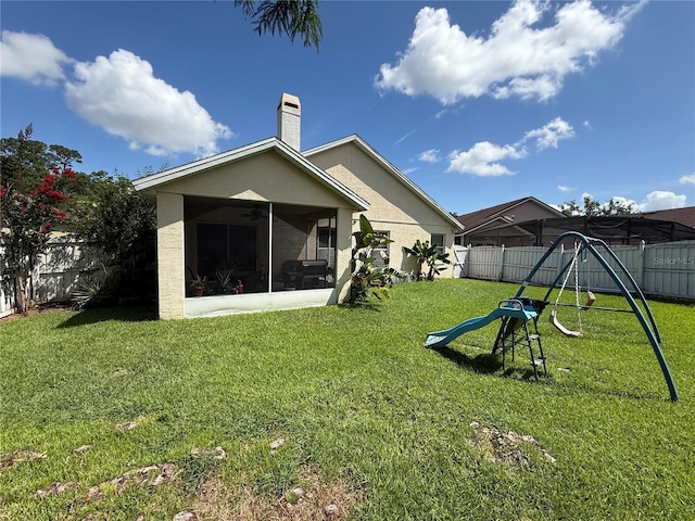 536 Dunoon St, Ocoee, FL 34761 - rear view of property featuring a playground, ceiling fan, a fenced backyard, and a sunroom