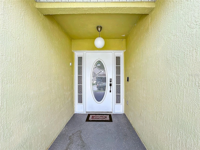 property entrance with stucco siding