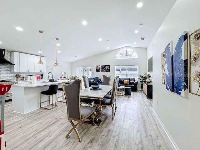 dining room featuring lofted ceiling, light wood-type flooring, visible vents, and recessed lighting