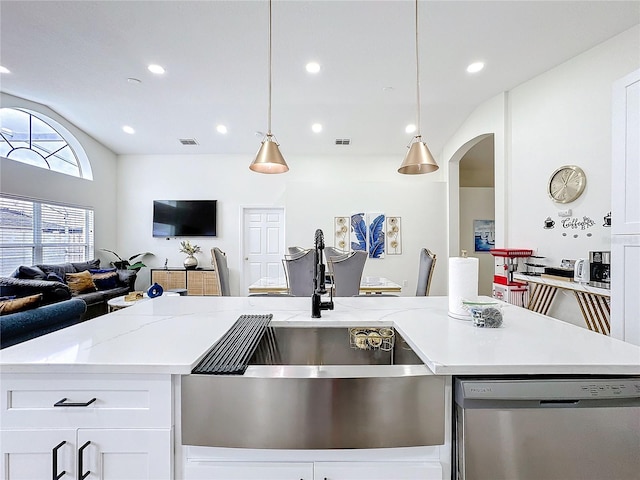 kitchen featuring visible vents, arched walkways, dishwasher, open floor plan, and a sink