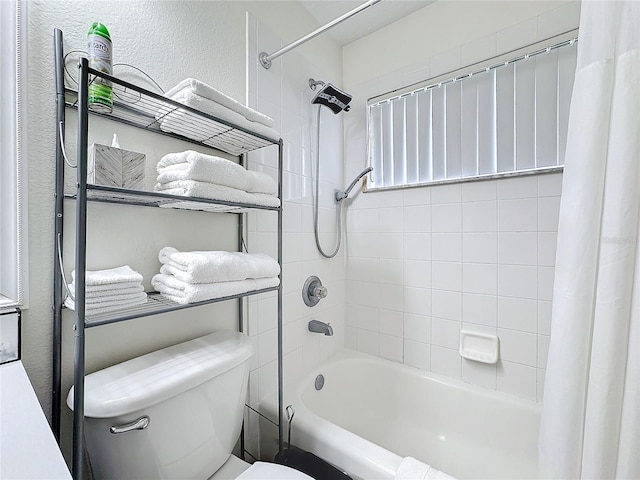 bathroom featuring a textured wall, toilet, and shower / tub combo with curtain