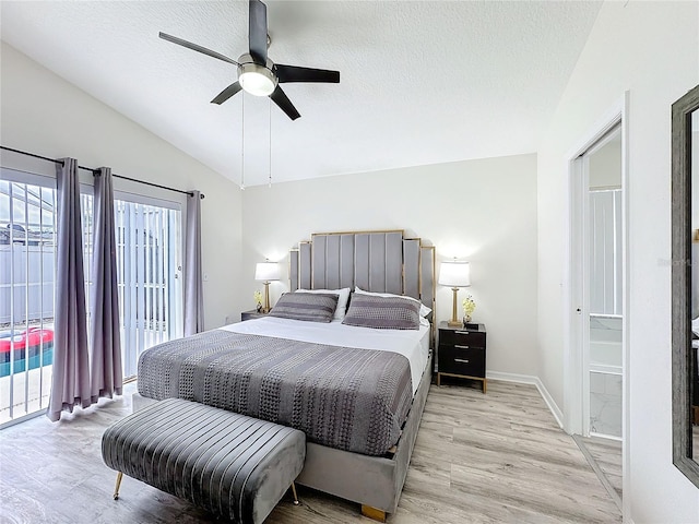 bedroom with baseboards, light wood-style flooring, access to outside, vaulted ceiling, and a textured ceiling