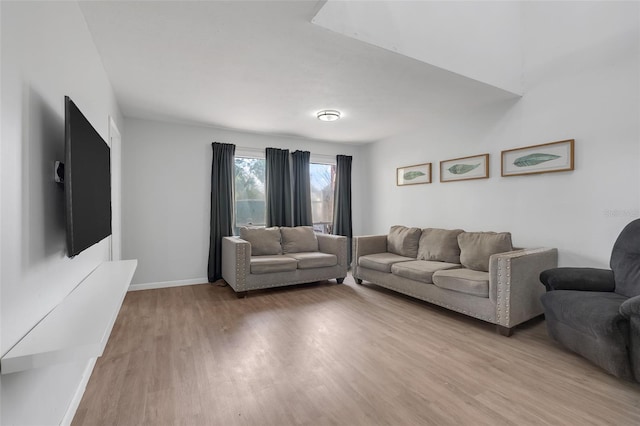 living room featuring light wood-style flooring and baseboards