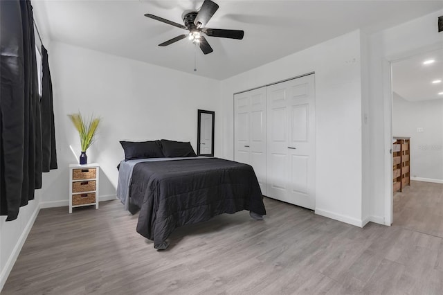 bedroom with light wood finished floors, recessed lighting, a closet, ceiling fan, and baseboards