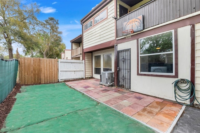 view of patio / terrace with a fenced backyard, a balcony, and central air condition unit