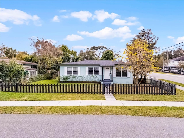 ranch-style home with a fenced front yard and a front yard