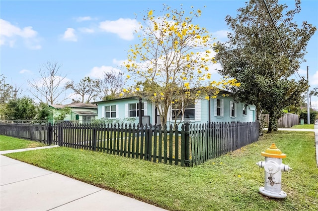 view of front of home with a fenced front yard and a front yard