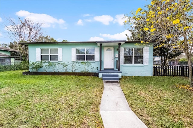 view of front facade featuring a front yard and fence