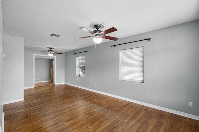 unfurnished room featuring visible vents, ceiling fan, baseboards, and wood finished floors