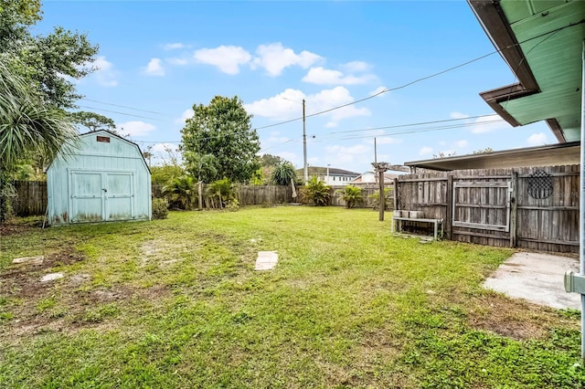 view of yard with a storage shed, an outdoor structure, and a fenced backyard