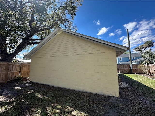 view of side of home with a fenced backyard