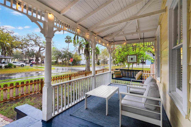 wooden deck featuring a porch and a water view