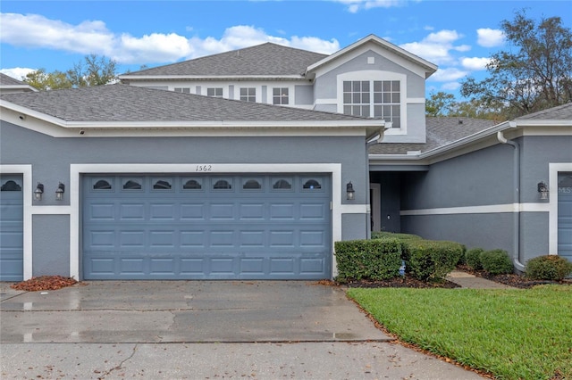 1562 Travertine Ter, Sanford, FL 32771 - traditional-style house with a garage, concrete driveway, a shingled roof, and stucco siding