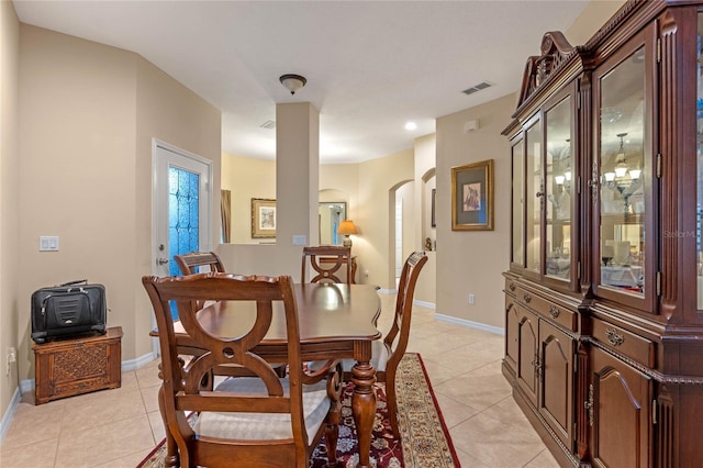 1562 Travertine Ter, Sanford, FL 32771 - dining area with arched walkways, visible vents, baseboards, and light tile patterned flooring