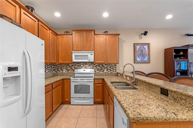 1562 Travertine Ter, Sanford, FL 32771 - kitchen with light stone counters, decorative backsplash, a sink, white appliances, and a kitchen bar