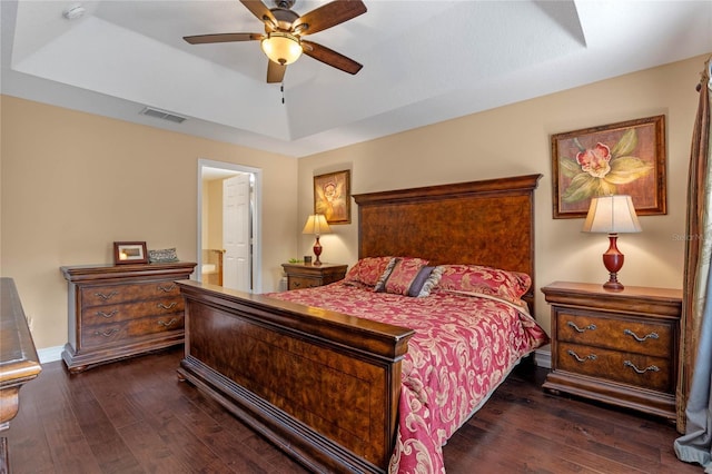 1562 Travertine Ter, Sanford, FL 32771 - bedroom featuring ensuite bath, visible vents, a raised ceiling, and dark wood-type flooring
