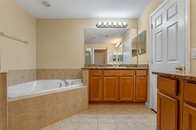 1562 Travertine Ter, Sanford, FL 32771 - full bath featuring a garden tub, vanity, a textured ceiling, and tile patterned floors
