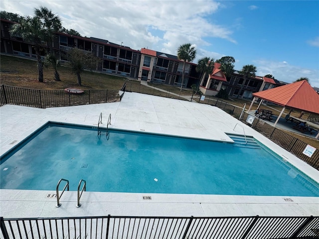 pool featuring fence and a gazebo