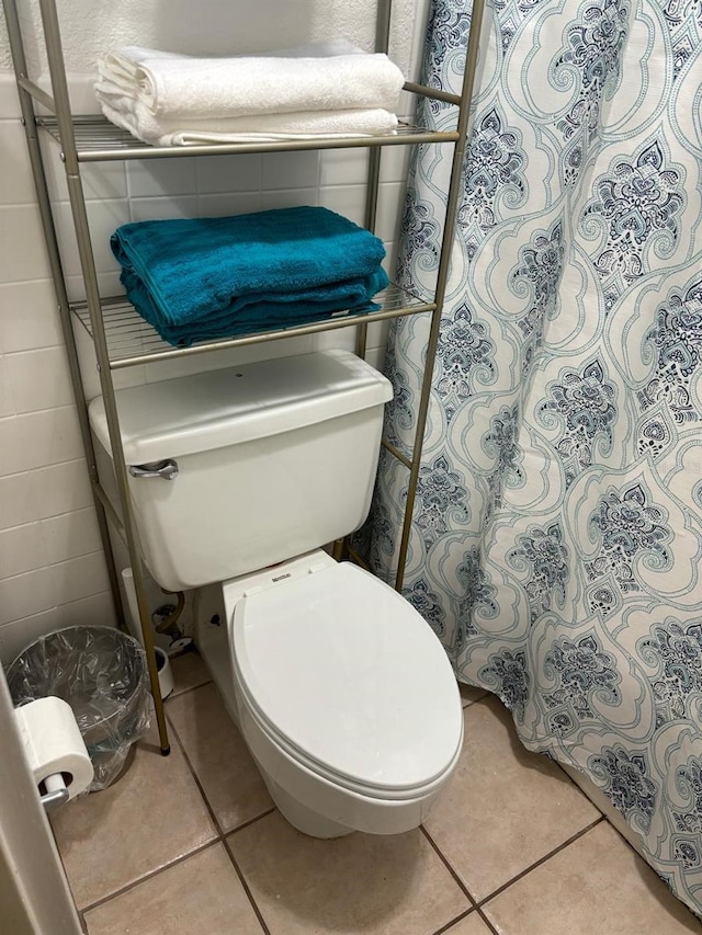 bathroom featuring toilet and tile patterned floors