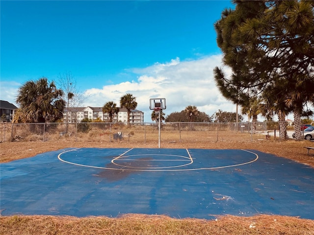 view of basketball court featuring community basketball court and fence