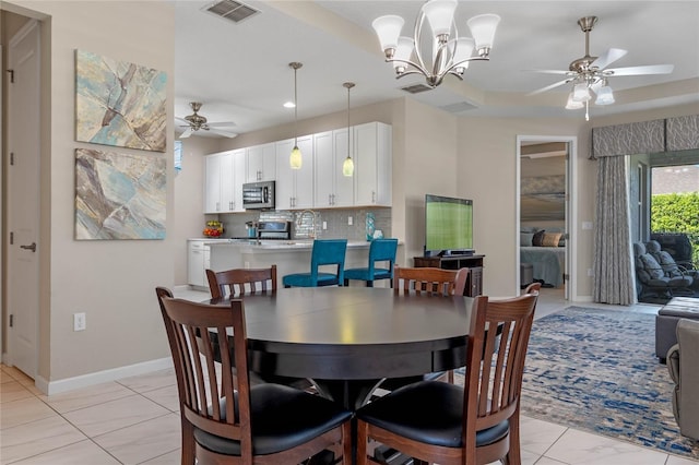 dining room with visible vents, baseboards, and ceiling fan with notable chandelier