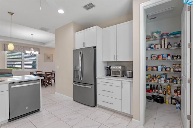 kitchen featuring decorative light fixtures, stainless steel appliances, visible vents, white cabinetry, and light stone countertops