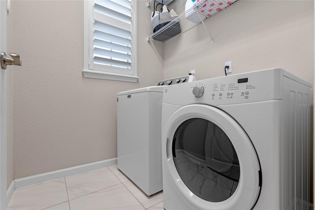 laundry area featuring laundry area, independent washer and dryer, and baseboards