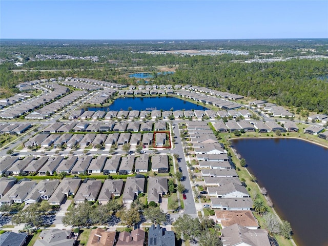 drone / aerial view with a water view and a residential view